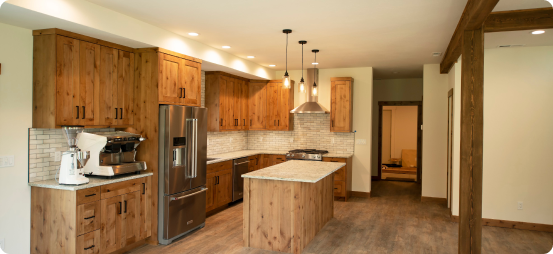 A kitchen with wooden cabinets and a refrigerator.